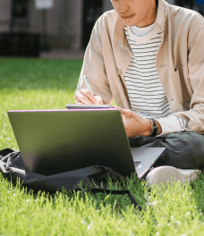 A man is working in front of a laptop