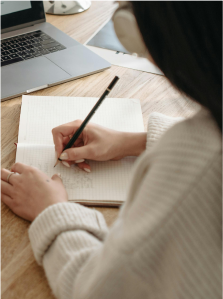 Woman writing in a piece of paper